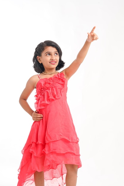 Cute indian little girl giving expression on white background