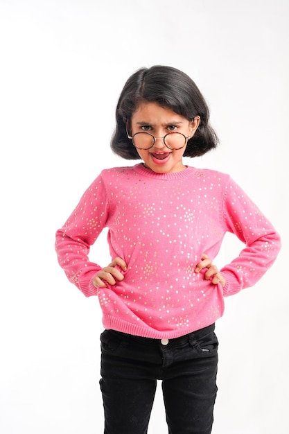 Cute indian little girl giving expression on white background