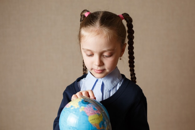 Cute kid with globe. The concept of education