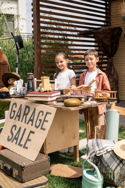 Cute kids at table with unnecessary things