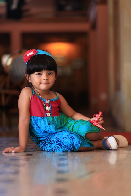 cute little asia girl sitting on the floor