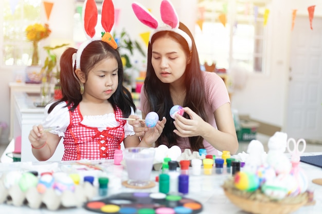 Cute little asian child girl wearing bunny ears on Easter day.