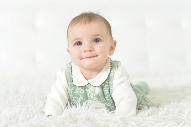 Cute little baby girl on white blanket