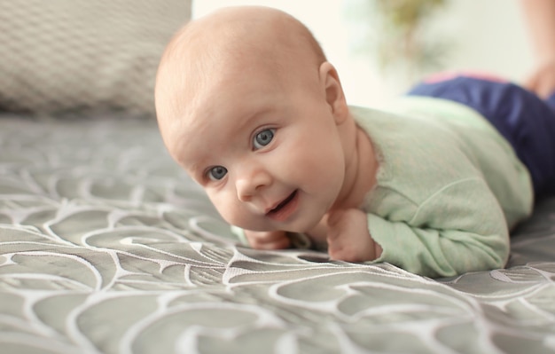 Cute little baby lying on bed