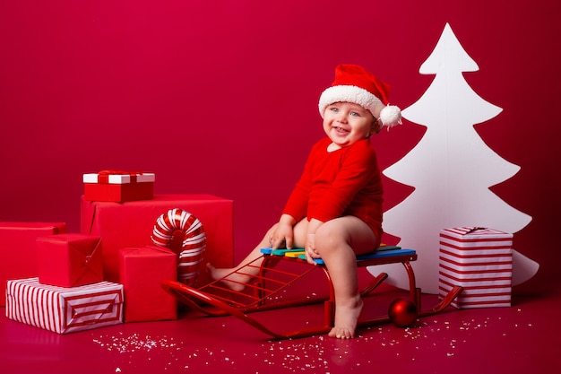 Cute little baby on a sleigh at Christmas