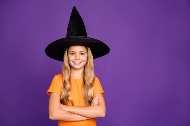 Cute little blonde girl with a witch hat