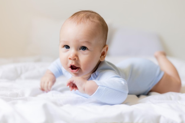 cute little boy in blue body laying on blanket, card, banner, health, space for text