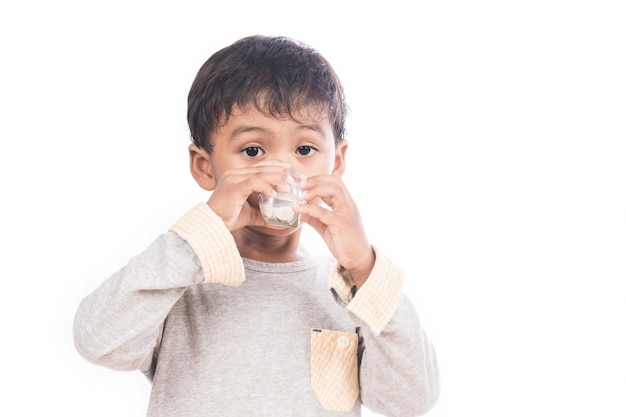 Cute little boy drinking milk