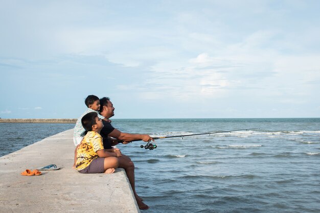 Cute little boy fishing at sea