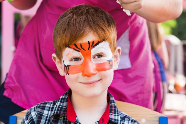 Cute little boy getting a face painting