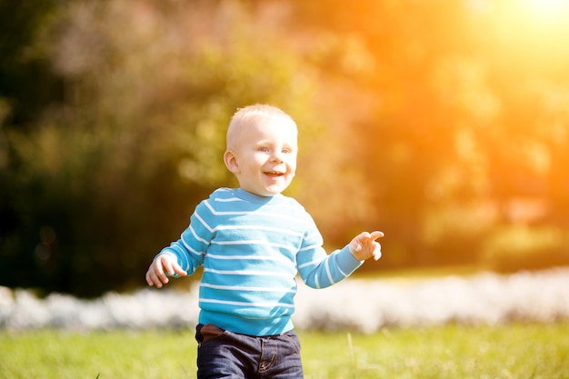 Cute little boy having fun in autumn park