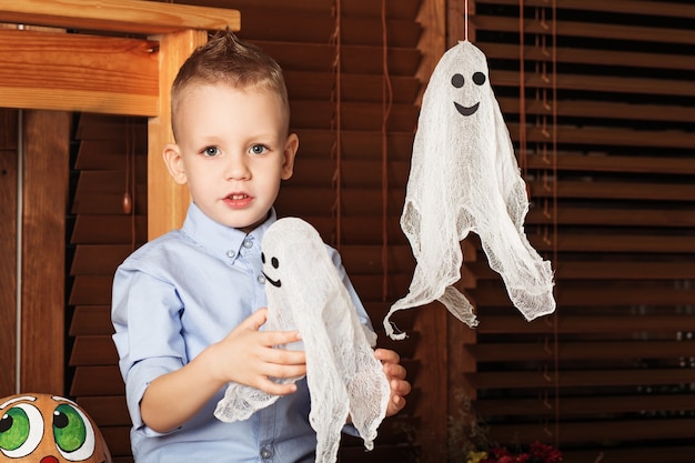 Cute Little Boy having fun in Halloween decorations