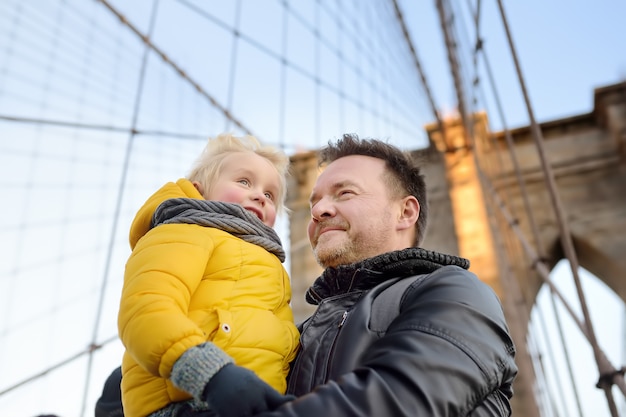 Cute little boy and his father on Brooklyn Bridge