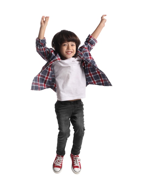 Cute little boy jumping on white background