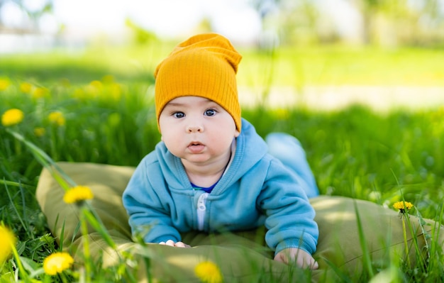 Cute little boy laying on a grass Summer outdoor childhood joy