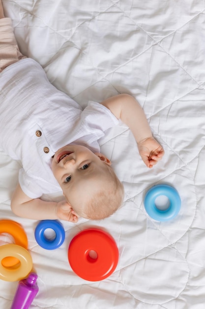 cute little boy playing with toys on blanket, health, banner, card, space for text