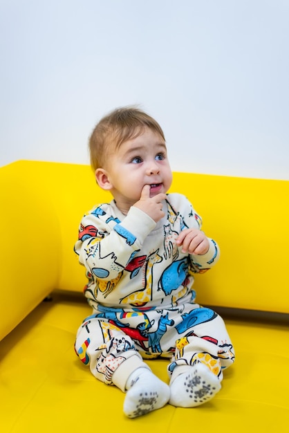 Cute little boy sitting Cheerful small child smilling