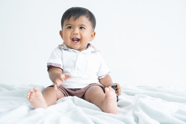 Cute little boy sitting and smile 