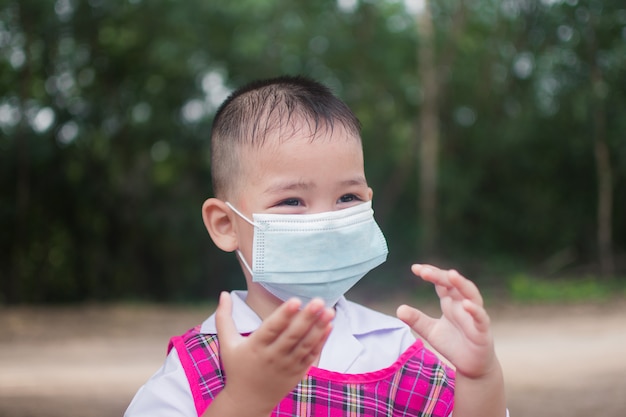 Cute little boy wear mask for protection coronavirus or covid 19.