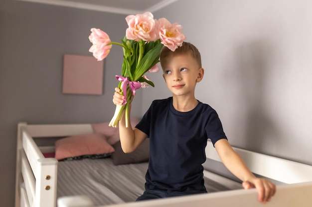 Cute little boy with a bouquet of flowers Tulips mothers Day International Women's Day