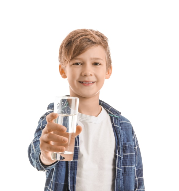 Cute little boy with glass of water on white