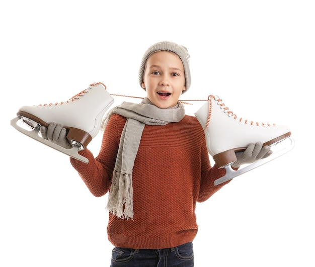 Cute little boy with ice skates against white