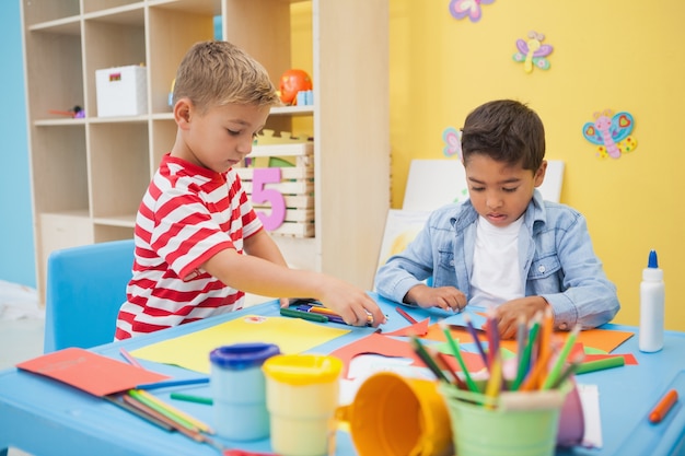 Cute little boys making art in classroom