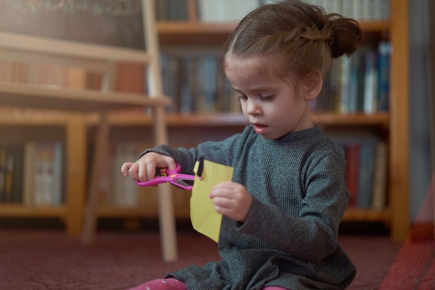 Cute little caucasian with scissors and paper