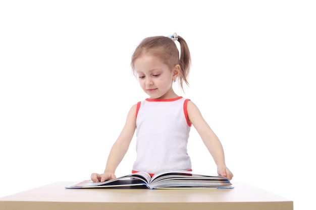 Cute little child reading a book