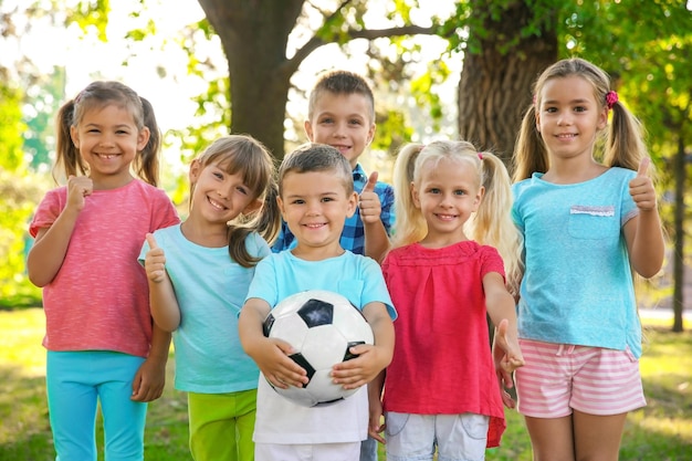 Cute little children with ball in park