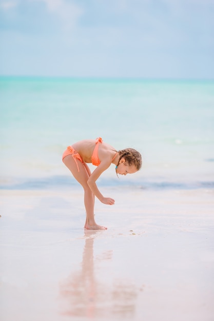 Cute little girl at beach during caribbean vacation