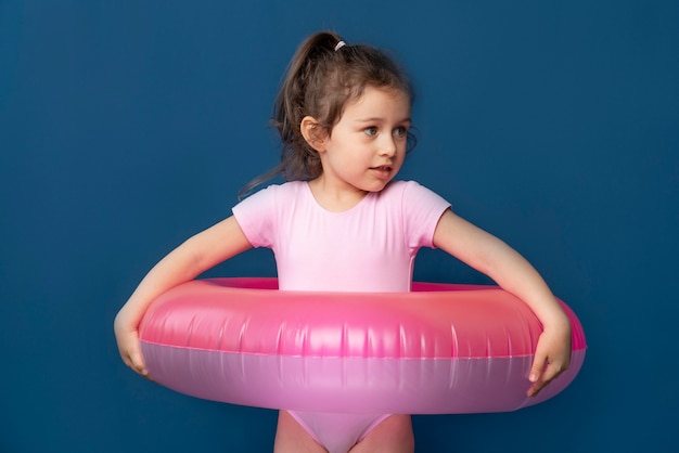 Cute little girl being ready for summer with a swimming ring