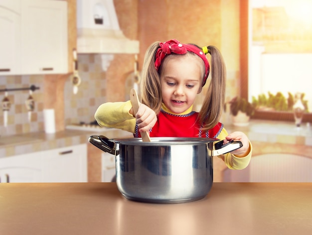 Cute little girl cooking at home