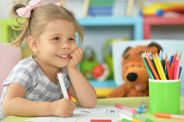 Cute little girl drawing with felt pen