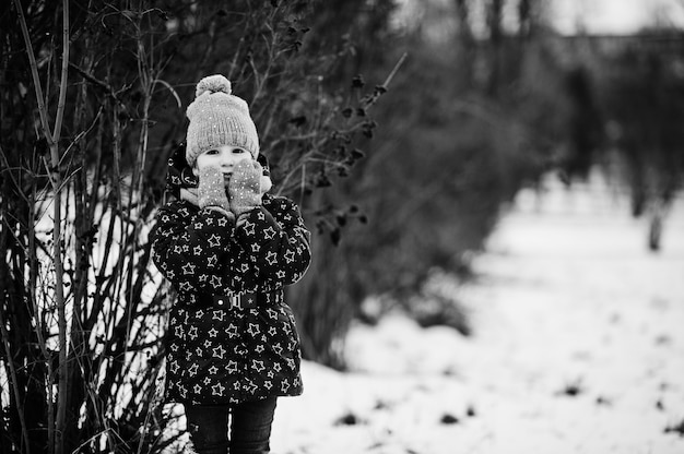 Cute little girl having fun outdoors on winter day.