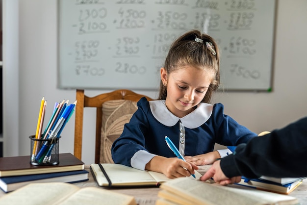 Cute little girl is pointed out by the teacher with his hand at her mistakes school concept parenting education