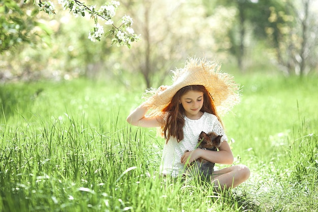 Cute little girl outdoor. Child on natural background. Kid in the grass