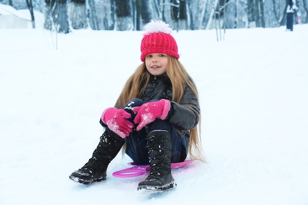 Cute little girl playing in winter park