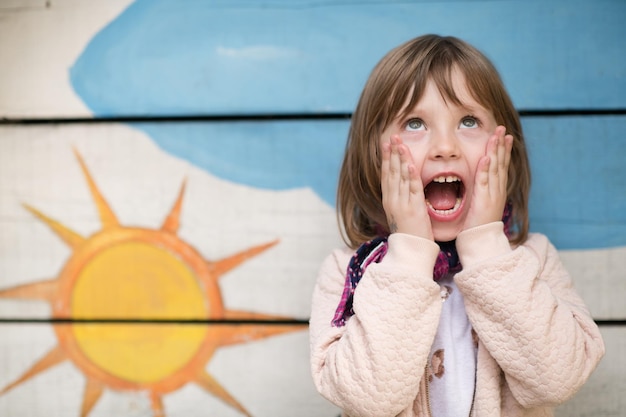 cute little girl portrait while  having fun in playground park on cludy autum day