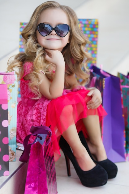 cute little girl shopping outdoors