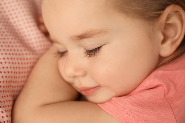 Cute little girl sleeping in bed at home closeup