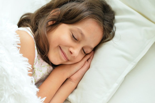 Cute little girl sleeping in bed