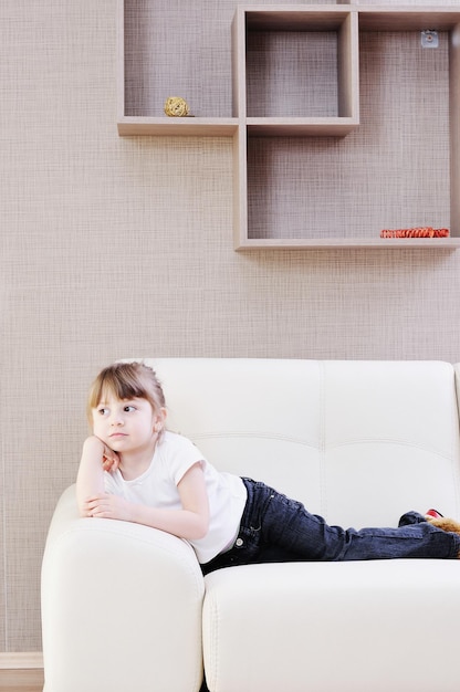 cute little girl on sofa at home