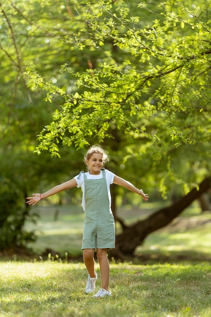 Cute little girl standing in the park