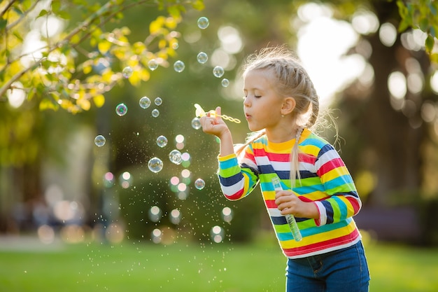 Cute little girl on a walk in a multi-colored knitted blouse