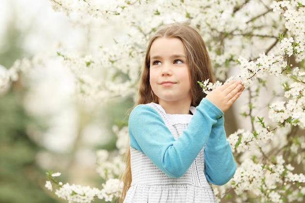 Cute little girl walking in spring park