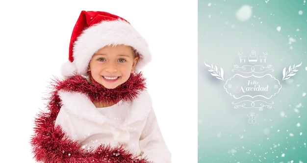 Cute little girl wearing santa hat and tinsel against green vignette