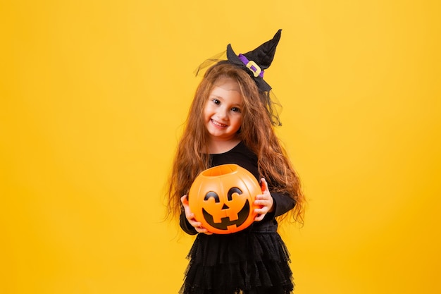 Cute little girl in a witch Halloween costume