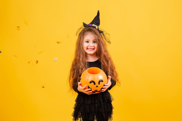 Cute little girl in a witch Halloween costume