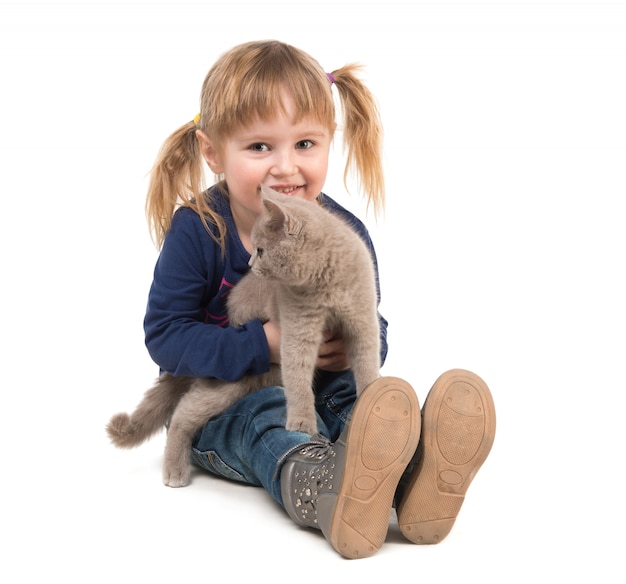 Cute little girl with cat in hands